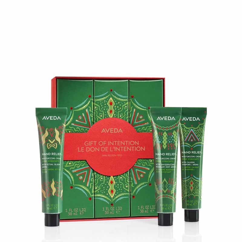 Aveda Gift of Intention hand relief gift set featuring a green patterned box with a red center label and three matching hand relief tubes in front, photographed on a white background.