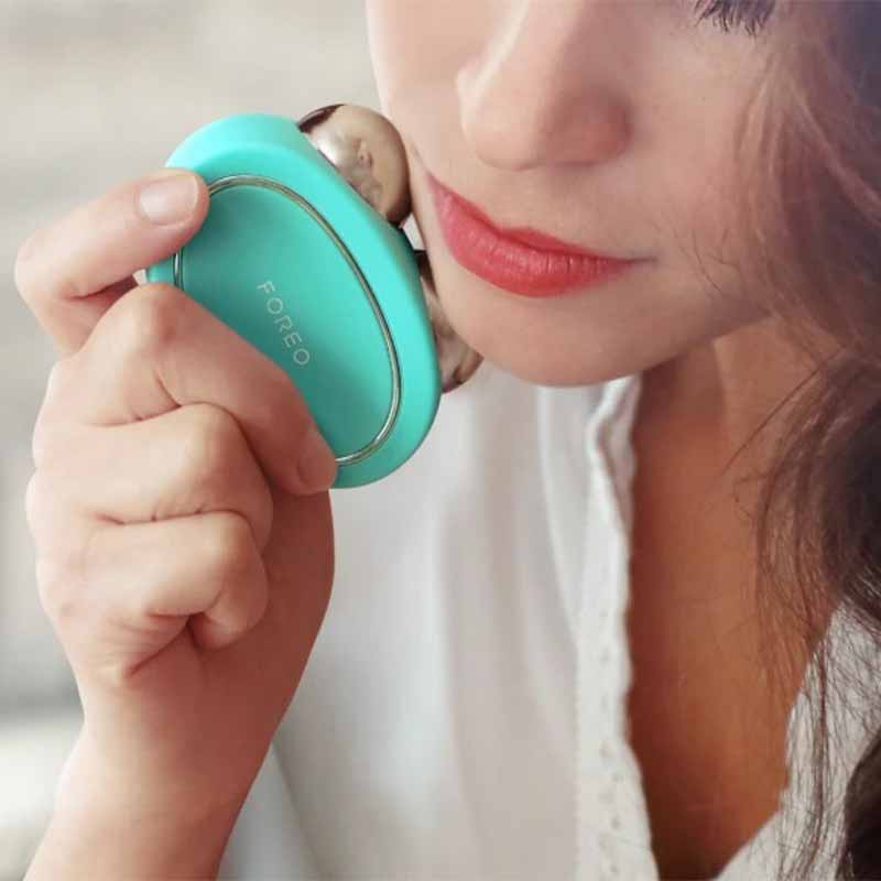 Foreo Bear | microcurrent | toning device | Anti-Shock System™ | full facial | workout | 2 minutes | clinically proven | effective | facial device | market | gently stimulating | firming | 69 muscles | face | neck | appearance | aging | clinical results | science-backed | technologies | professional | facelift treatment | home | mint | fuschia | stand | serum | glide | jawline | cheekbone | forehead | light pressure