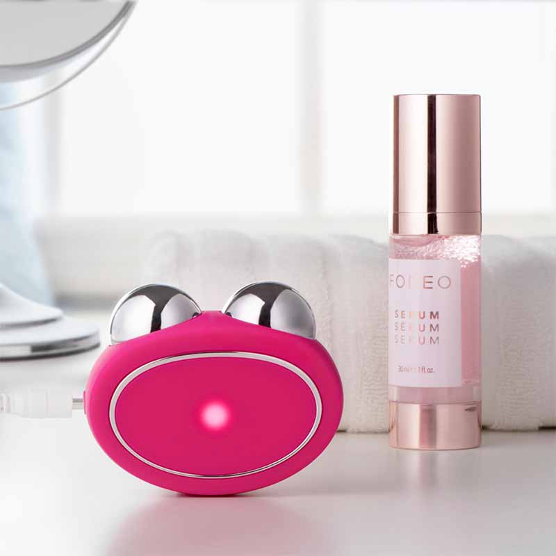 Foreo Bear | microcurrent | toning device | Anti-Shock System™ | full facial | workout | 2 minutes | clinically proven | effective | facial device | market | gently stimulating | firming | 69 muscles | face | neck | appearance | aging | clinical results | science-backed | technologies | professional | facelift treatment | home | mint | fuschia | stand | serum | glide | jawline | cheekbone | forehead | light pressure