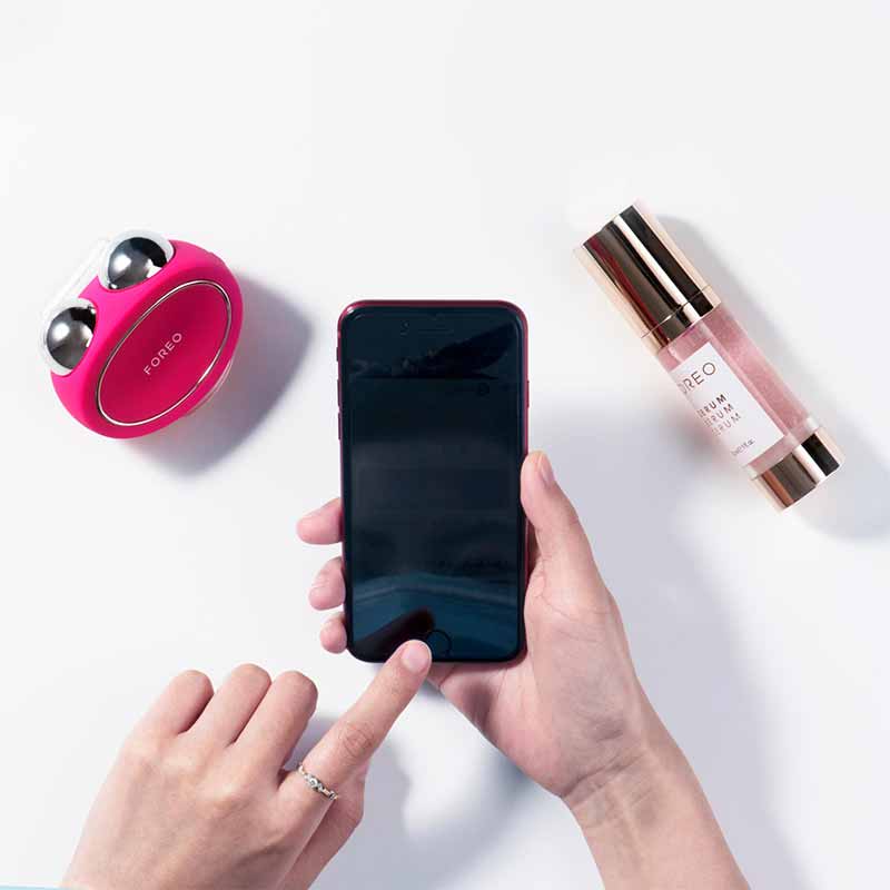 Foreo Bear | microcurrent | toning device | Anti-Shock System™ | full facial | workout | 2 minutes | clinically proven | effective | facial device | market | gently stimulating | firming | 69 muscles | face | neck | appearance | aging | clinical results | science-backed | technologies | professional | facelift treatment | home | mint | fuschia | stand | serum | glide | jawline | cheekbone | forehead | light pressure