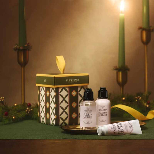 L'Occitane Fleurs De Cerisier (Cherry Blossom) Christmas Ornament Christmas stylised image of products with a candle light backdrop