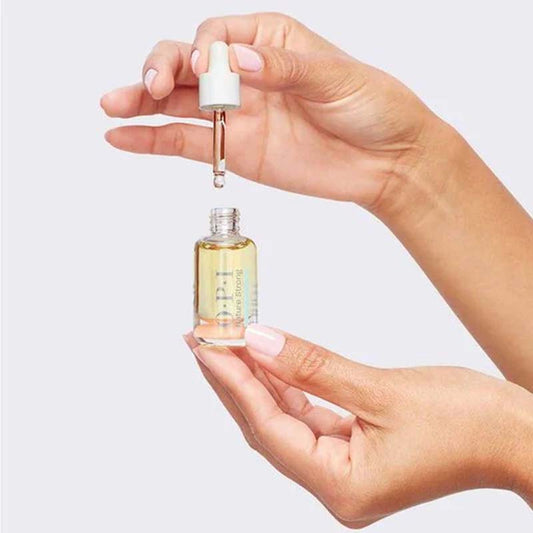 OPI Nature Strong Glow Up Nail & Cuticle Oil 8ml dropping i9mage of woman holding the product and dropper