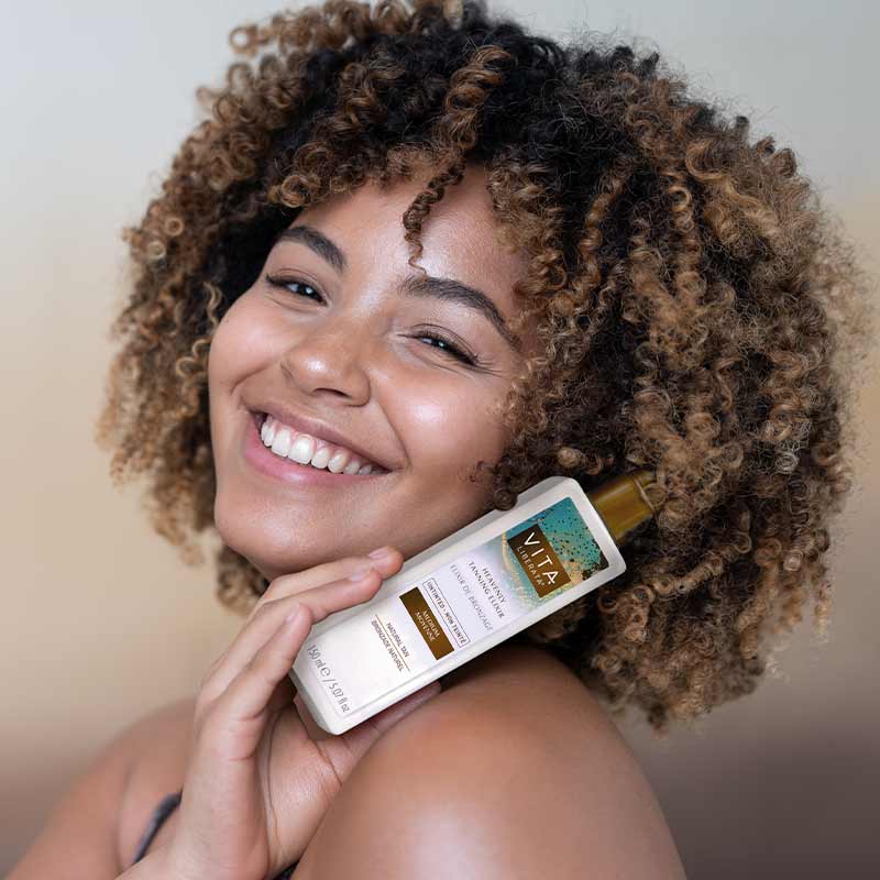 Vita Liberata Heavenly Tanning Elixir Untinted | shade medium clear self tan on model