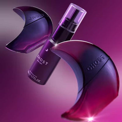 A purple and black perfume bottle labeled GHOST by Chloé, shown with two matching crescent-shaped decorative pieces on a pink-purple gradient background.