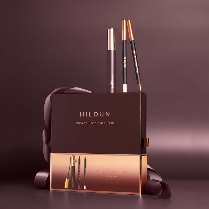 Hildun Beauty Power Precision Set Pecan Makeup Gift Set burgundy background products standing on top of packaging box