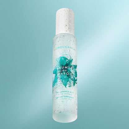 Moroccanoil Brumes du Maroc Hair and Body Mist blue background image with droplets of water on the bottle stylised image