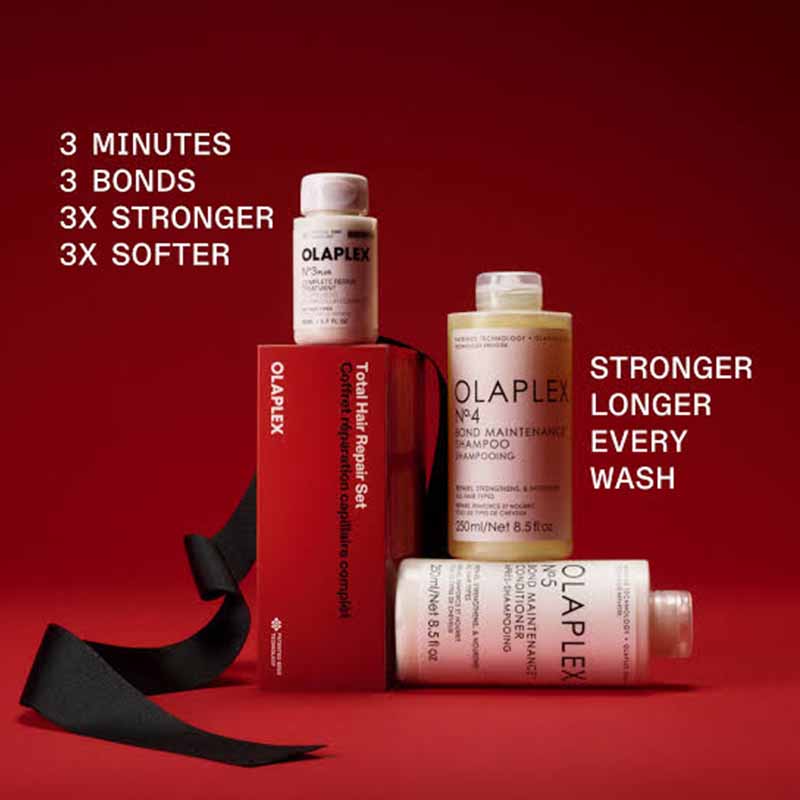 Ola Plex Total Hair Repair Set featuring a red box, shampoo bottle, conditioner bottle, and a black ribbon on a dark red background with promotional text.