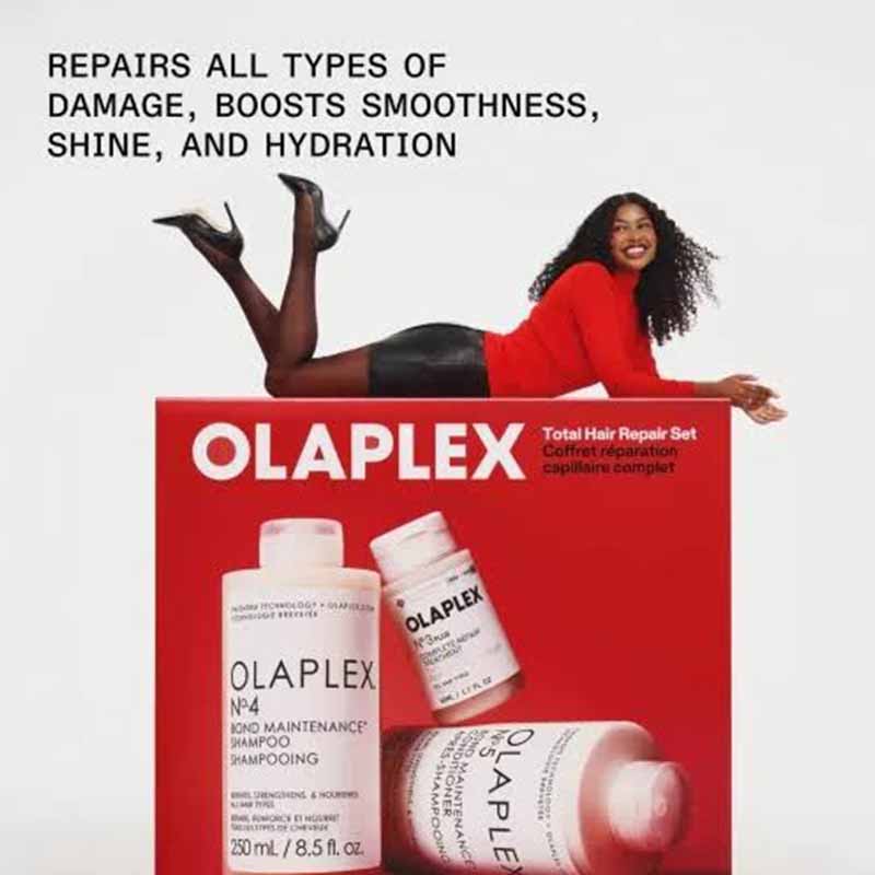 Olaplex hair repair set advertisement featuring a model reclining above a red box of Olaplex Total Hair Repair Set, with three hair care bottles shown on the box and text at the top.