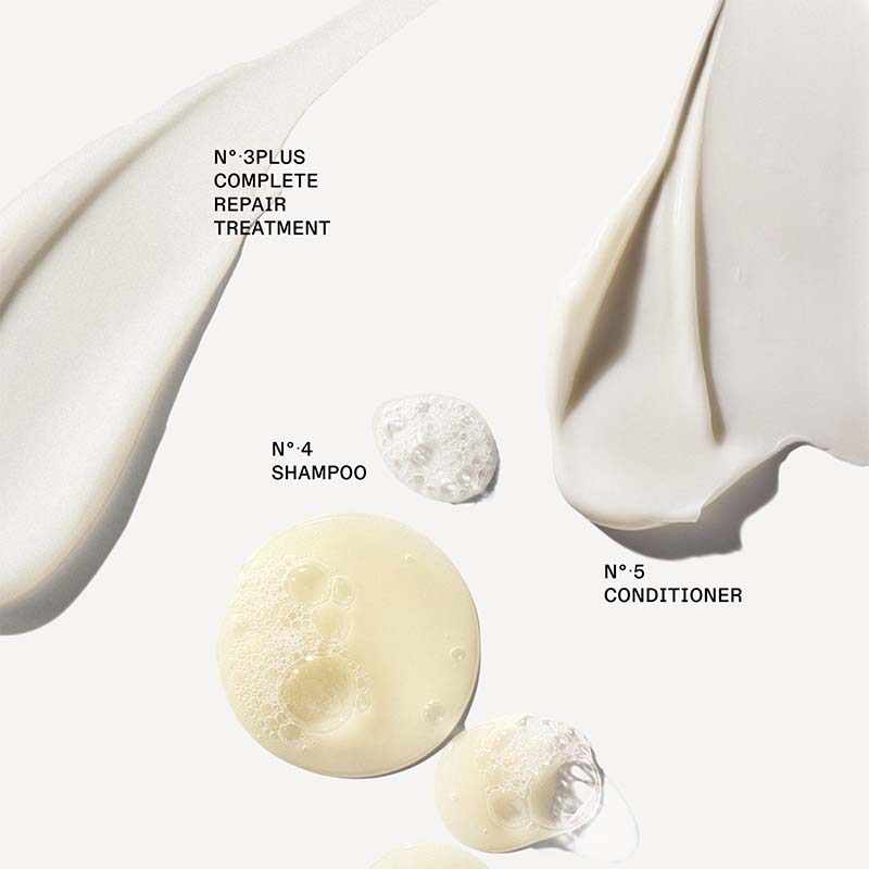 A clean cosmetic product graphic on a warm off-white background showing several cream and foam textures with black text labels: 'N°3PLUS COMPLETE REPAIR TREATMENT,' 'N°4 SHAMPOO,' and 'N°5 CONDITIONER.' No person, animal, or real environment is present, so this is Product/Packaging rather than Lifestyle.
