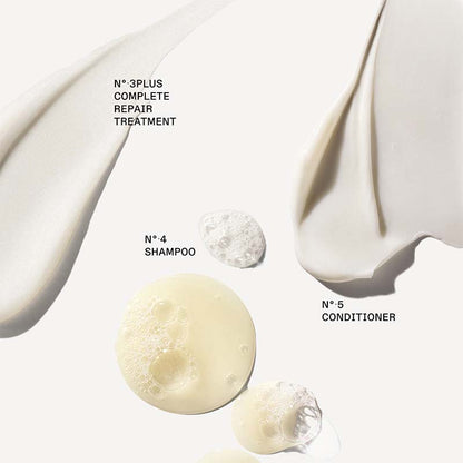 A clean cosmetic product graphic on a warm off-white background showing several cream and foam textures with black text labels: 'N°3PLUS COMPLETE REPAIR TREATMENT,' 'N°4 SHAMPOO,' and 'N°5 CONDITIONER.' No person, animal, or real environment is present, so this is Product/Packaging rather than Lifestyle.