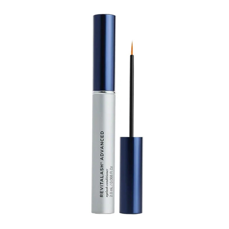 Revitalash Advanced eyelash serum in a silver and navy blue tube, shown with the cap removed and the applicator wand standing beside it on a white background.