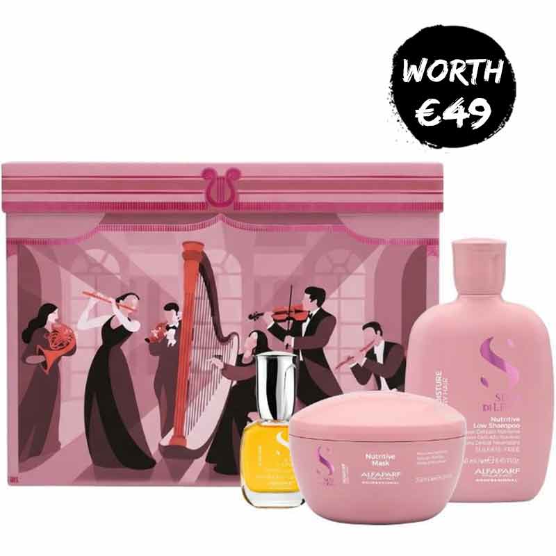 A pink alfaparf gift set featuring a large illustrated pink box with musicians, a pink shampoo bottle, a pink body butter jar, and a small yellow perfume bottle, with a black circular badge reading 'WORTH €49' in the top right.