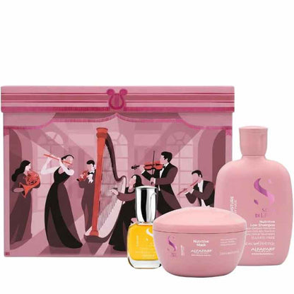 A pink hair care gift set featuring a large illustrated presentation box with musicians, a large pink bottle, a pink jar, and a small yellow bottle, all arranged on a white background.