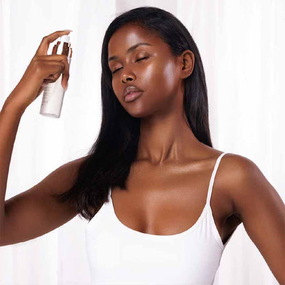 Bellamianta Celestial Skin Dream Setting Mist image of a woman spraying the product over her face