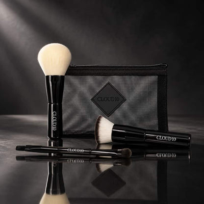 Cloud 10 On the Go Travel Brush Set with black makeup brushes and mesh makeup bag on a dark reflective surface