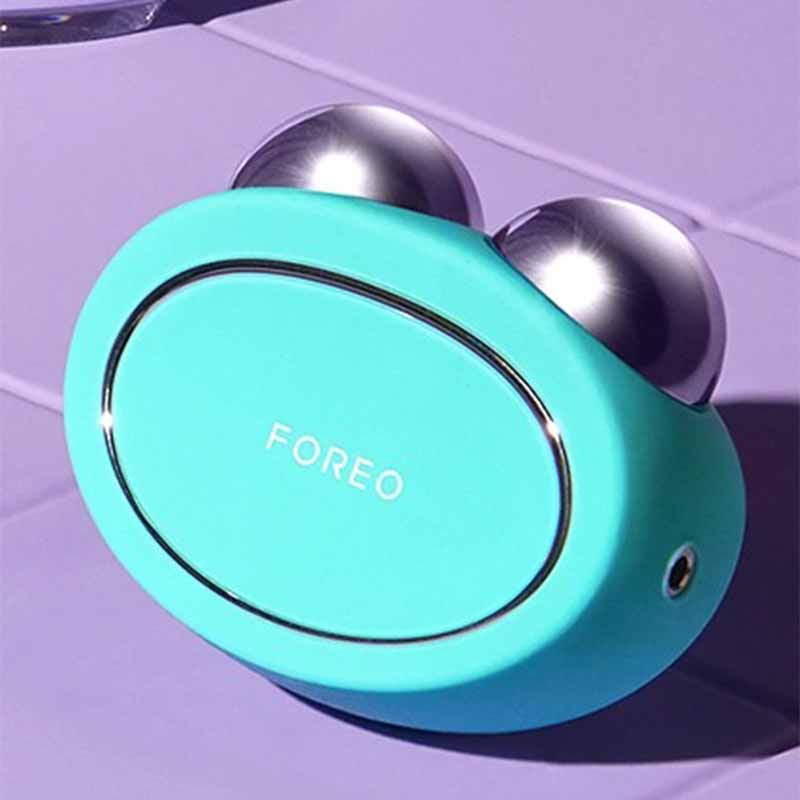 Foreo Bear | microcurrent | toning device | Anti-Shock System™ | full facial | workout | 2 minutes | clinically proven | effective | facial device | market | gently stimulating | firming | 69 muscles | face | neck | appearance | aging | clinical results | science-backed | technologies | professional | facelift treatment | home | mint | fuschia | stand | serum | glide | jawline | cheekbone | forehead | light pressure