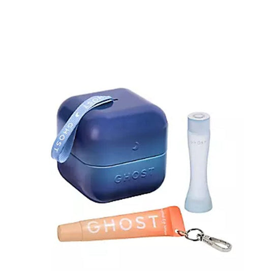 A Ghost brand travel set featuring a blue gradient square earbud case with a blue strap, a light blue cylindrical travel bottle, and an orange travel lip balm tube with a silver keychain clip, all on a white background.