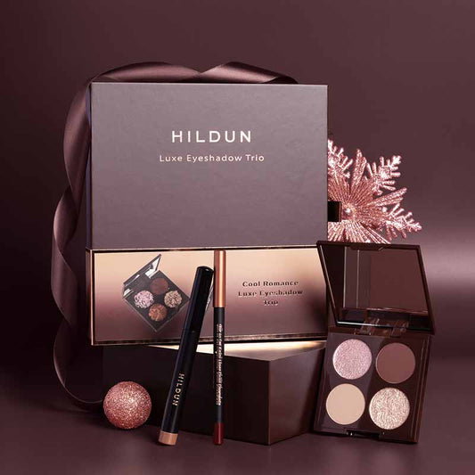 Hildun Beauty Cool Romance Makeup Gift Set stylised image of products sitting in front of box, burgundy brand colours backdrop