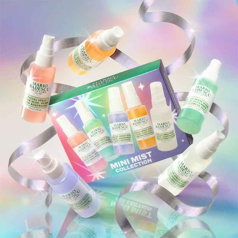 Mario Musu Mini Mist Collection featuring six small spray bottles in assorted pastel colors arranged around a matching illustrated product box on a reflective pastel surface with silver ribbon accents.