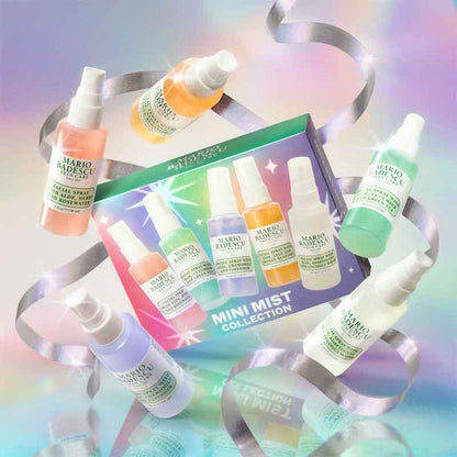Mario Musu Mini Mist Collection featuring six small spray bottles in assorted pastel colors arranged around a matching illustrated product box on a reflective pastel surface with silver ribbon accents.