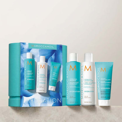 Morocconoil Hydrating Kit Box With Products On A Marble Shelf With Neutral Background Wall