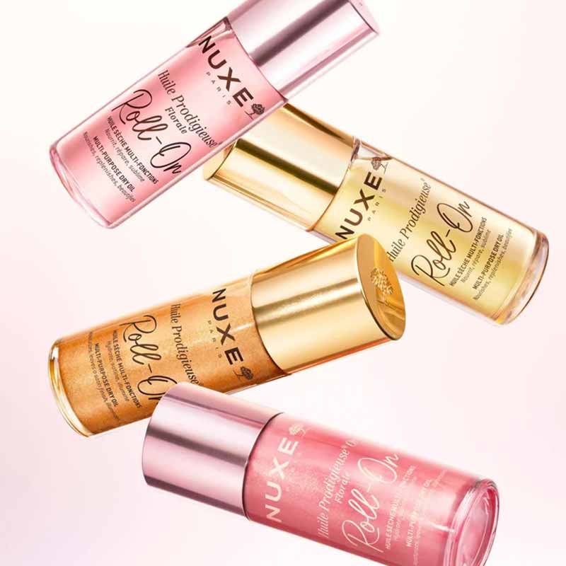 NUXE Huile Prodigieuse Floral Gold Shimmer Multi-Purpose Dry Oil image beside the other 3 NUXE roll on shades 