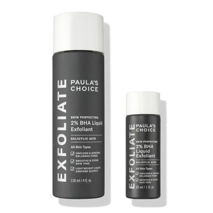Paula's Choice Exfoliate 2% BHA Liquid Exfoliant shown in two sizes: a larger 110 ml bottle and a smaller 29 ml bottle, both in dark gray with white caps on a white background.