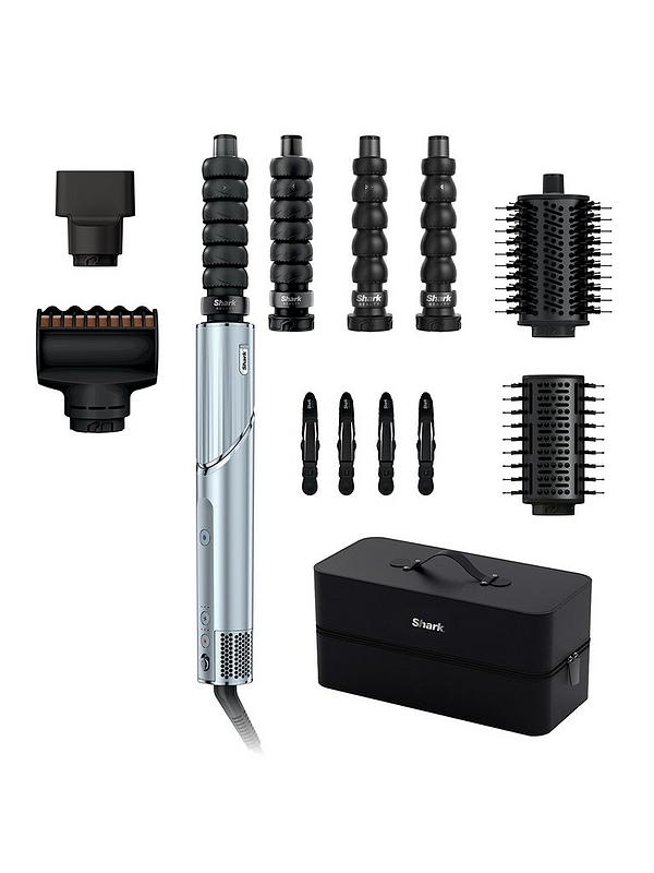 A hair styling tool kit on a white background, featuring a silver and black wand-style device, multiple black attachment heads, four round brush barrels, four small clips, and a black carrying case with the Shark logo.