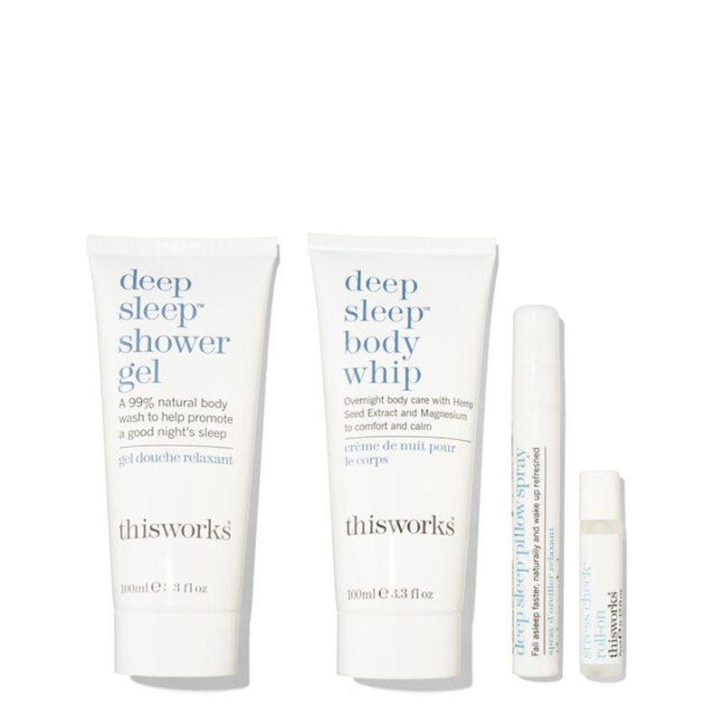 Thisworks Deep Sleep Shower Gel and Deep Sleep Body Whip set with two white tubes and two small white bottles on a clean white background.